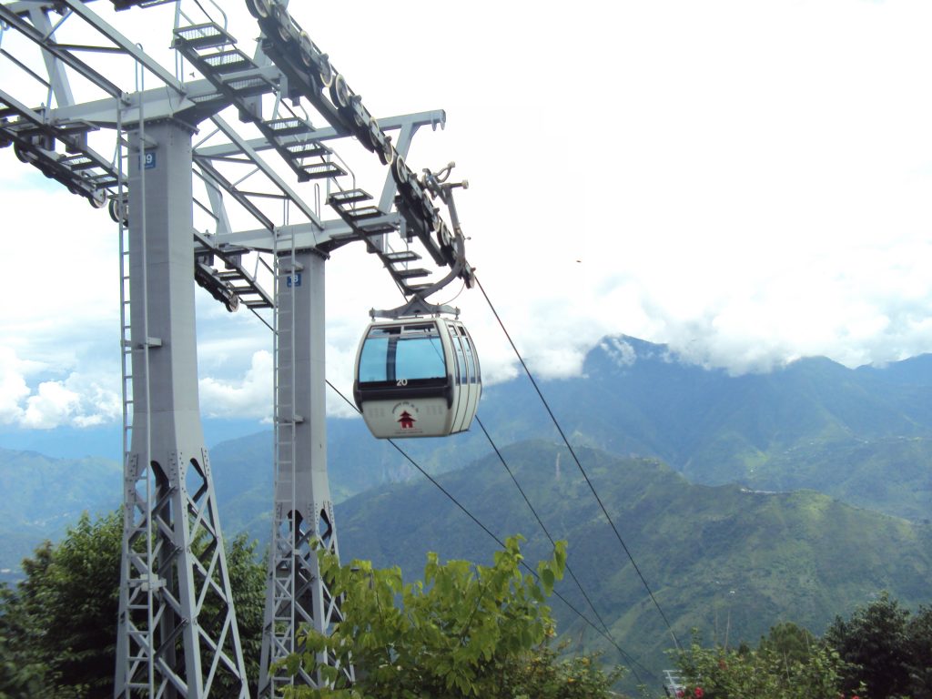 Private car and 4WD jeep at the Manakamana Cable Car station with Manakamana Temple in the background