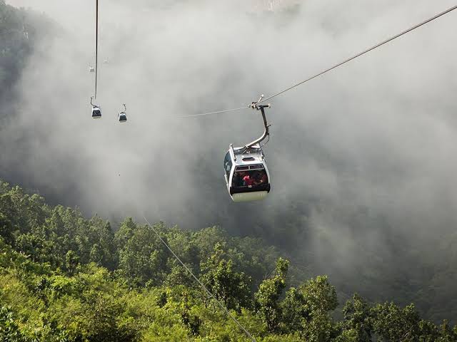 Private car and 4WD jeep at the Manakamana Cable Car station with Manakamana Temple in the background