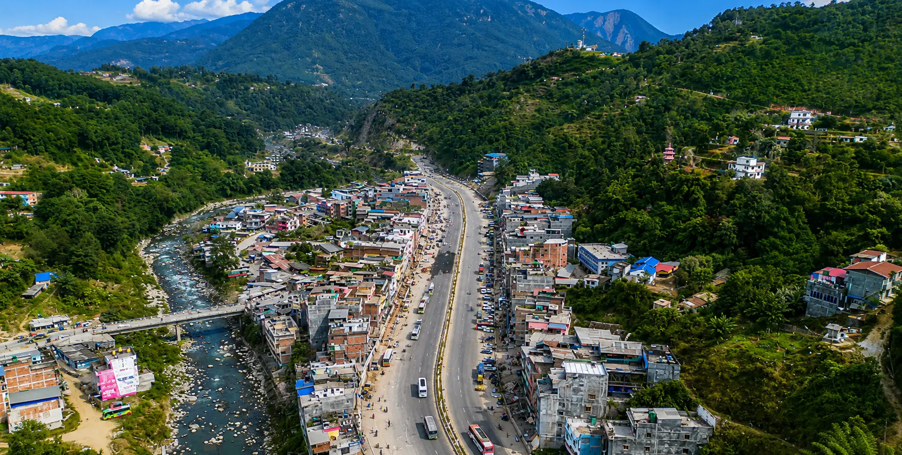 Kathmandu to Pokhara road conditions along the Prithvi Highway, with mountain scenery, rivers, and tourist vehicles in Nepal.