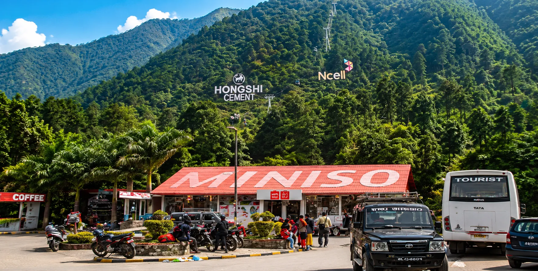 Private car and 4WD jeep at the Manakamana Cable Car station with Manakamana Temple in the background