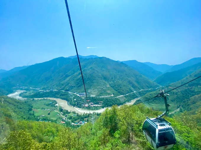 Private car and 4WD jeep at the Manakamana Cable Car station with Manakamana Temple in the background