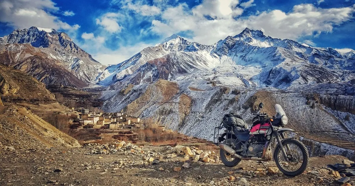 Royal Enfield Himalayan 450 adventure motorcycle in Mustang Valley with Himalayan mountains, Nepal.