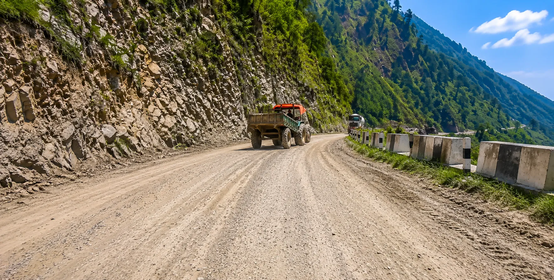 Kathmandu to Pokhara road conditions along the Prithvi Highway, with mountain scenery, rivers, and tourist vehicles in Nepal.